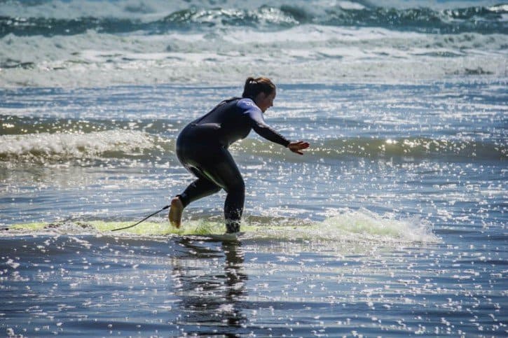 Lina Getting Up in Piha Piha Beach New Zealand - surfing