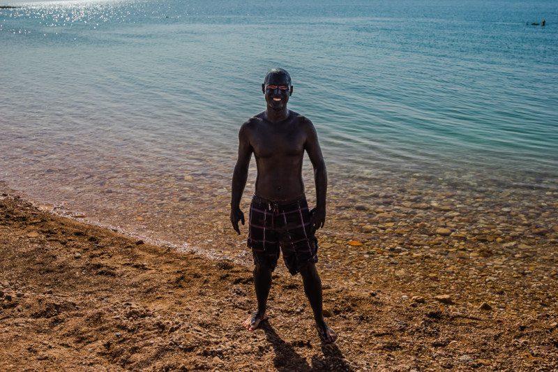 Guy covered in Dead Sea mug, Jordan