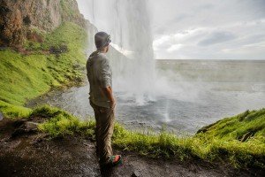 David Stock standing behind Seljalandsfoss in Iceland