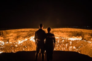 Divergent Travelers at Darvaza Gas Crater in Turkmenistan