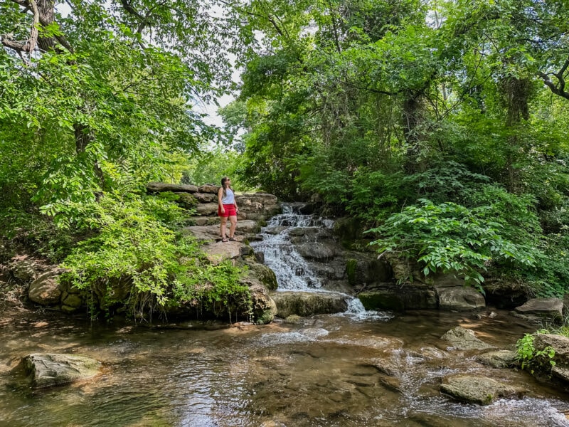 Lina Stock standing by a waterfall in Chickasaw Country Oklahoma